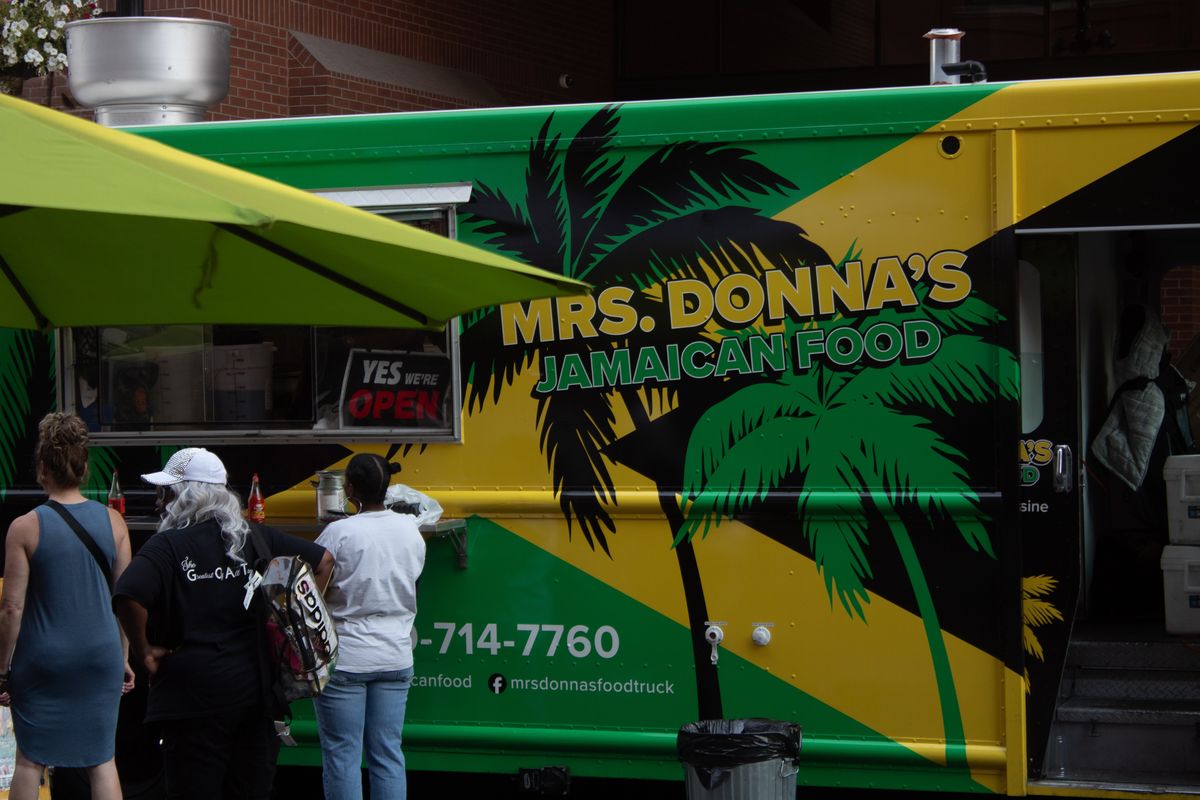 Mrs. Donna’s Jamaican Food Truck serves up food to people attending the Soul Food and Sips event in the East Central Neighborhood.  (Courtesy of Sunkissed Photos)