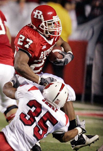 
Louisville's Brandon Sharp pulls down Ray Rice of Rutgers, who ran for 131 yards and two scores. 
 (Associated Press / The Spokesman-Review)