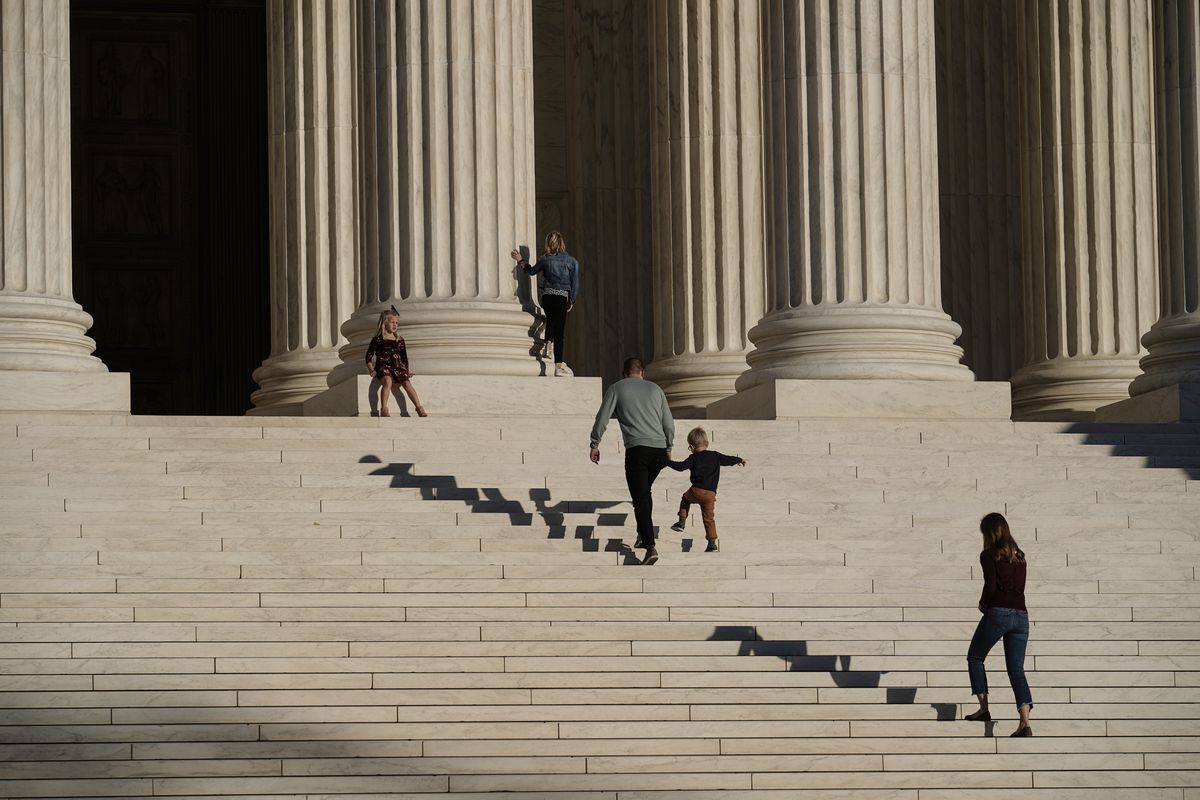 A family visits the Supreme Court in Washington, Wednesday, Nov. 4, 2020. The Trump campaign is seeking to intervene in a Pennsylvania case at the Supreme Court that deals with whether ballots received up to three days after the election can be counted.  (J. Scott Applewhite)