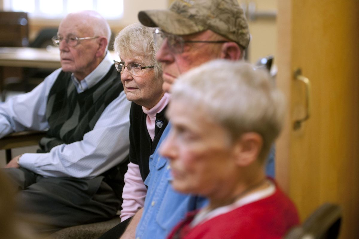 ALS Service Organization president Jerry Williams, far left along with volunteers Carol Williams, center left , Pat Priddy, center right and Cathey Priddy listen to members describe their experience with ALS before the meeting at Millwood Presbyterian Church on Wednesday, April 4, 2019. (Kathy Plonka / The Spokesman-Review)