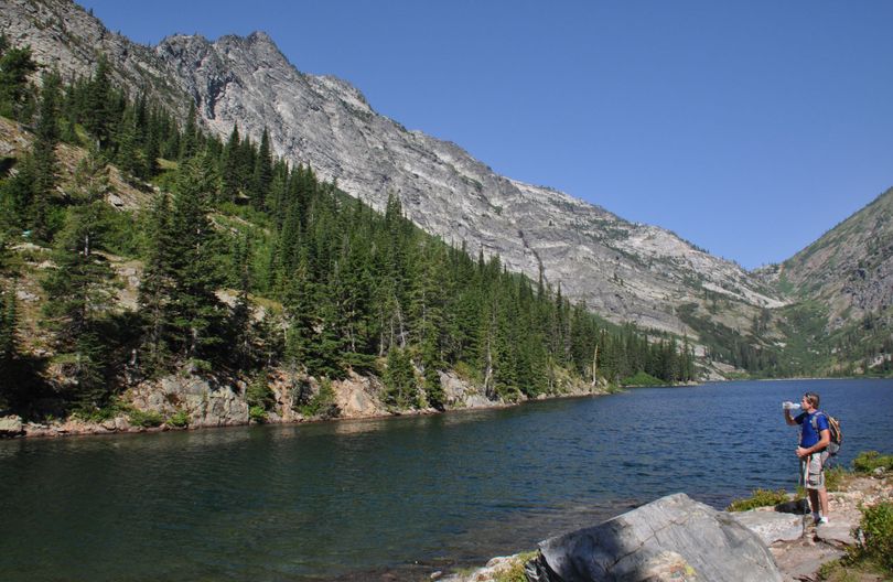 Jim Costello pauses during a summer hike at the main hiker campsite at Rock Lake in the Cabinet Mountains Wilderness of Montana. (Rich Landers)