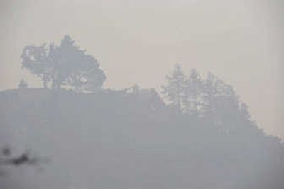 Haze from smoke obscures a home on a ridge overlooking the Pacific Ocean in Big Sur, Calif., on Tuesday. Airborne ash from hundreds of wildfires has caused a spike in air pollution in the area. Associated Press
 (Associated Press / The Spokesman-Review)