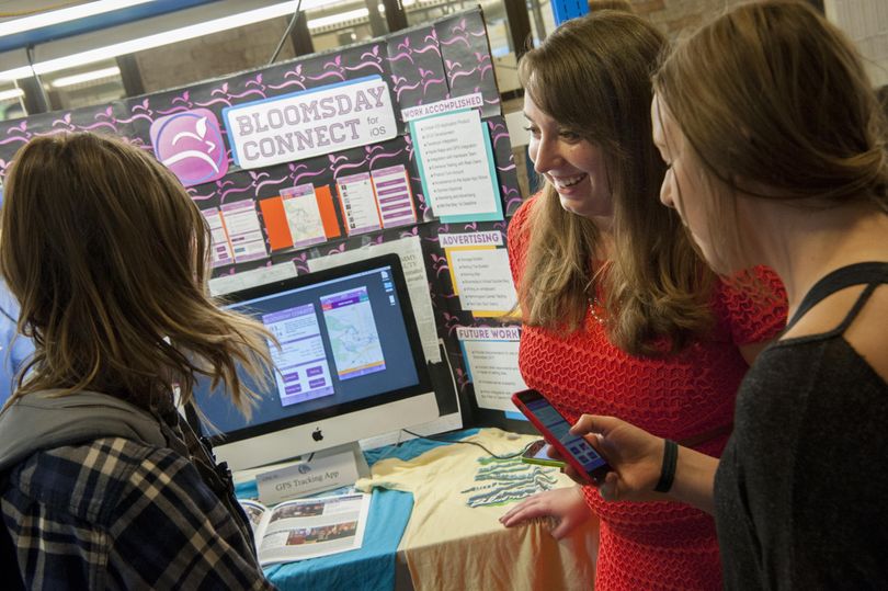 Kaitlin Anderson, second from right, shows Gonzaga students Shannon Noson, left and Kenzie Fuller right, a new Bloomsday app on Wednesday, April 27, 2016, at  Gonzaga University in Spokane, Wash. (Tyler Tjomsland / The Spokesman-Review)