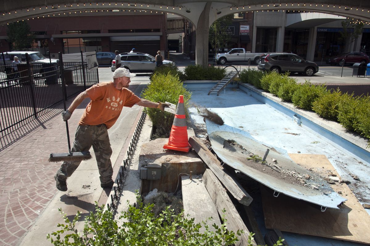 Randy Keller, of Rob’s Demolition, works on removing the Parkade Plaza Fountain in downtown Spokane on Monday. (Dan Pelle)