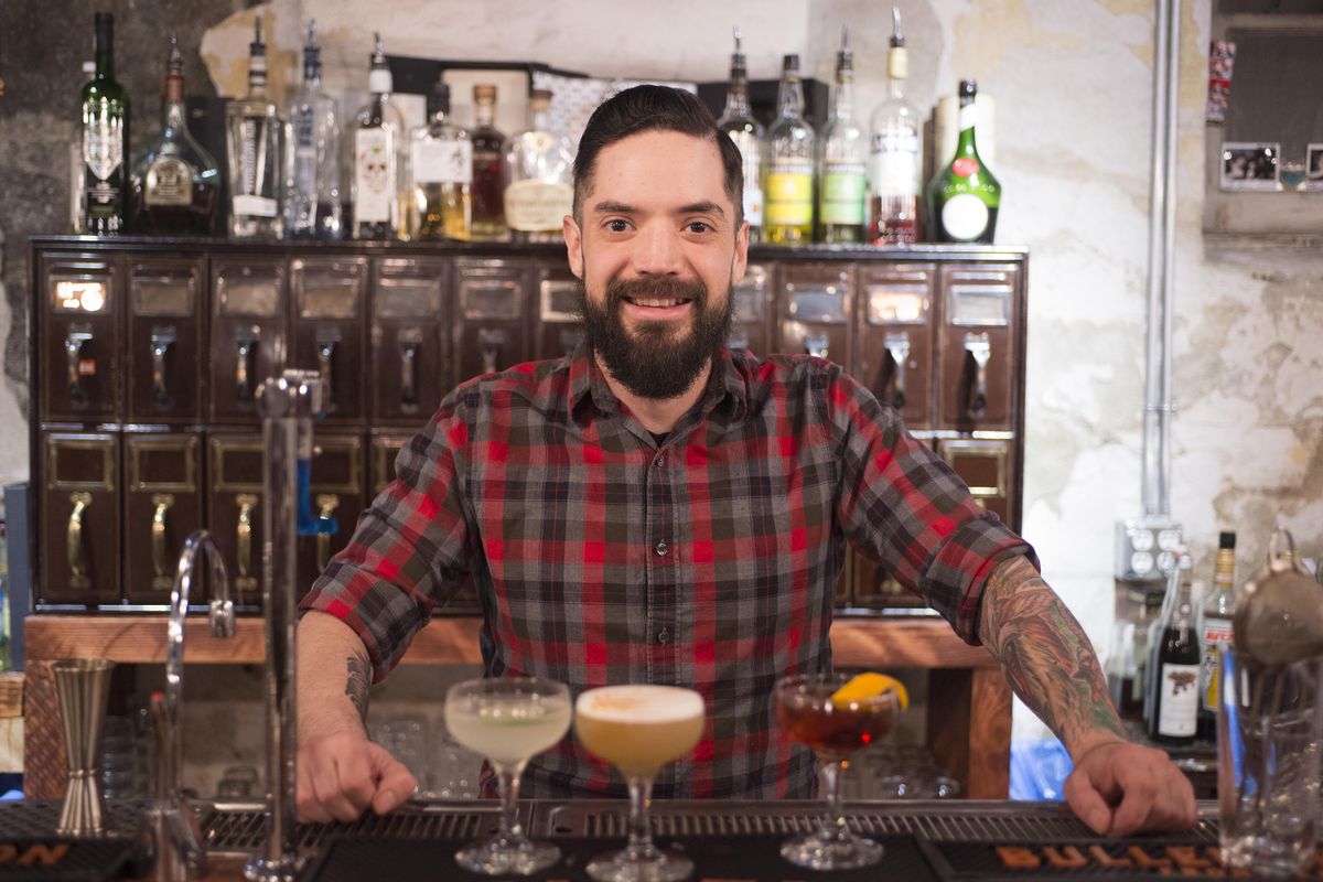 Simon Moorby of Hogwash Whiskey Den, a bar in the Washington Cracker Building in downtown Spokane, poses with some of his creations Tuesday, May 16, 2017.  Jesse Tinsley/THE SPOKESMAN-REVIEW (Jesse Tinsley / The Spokesman-Review)