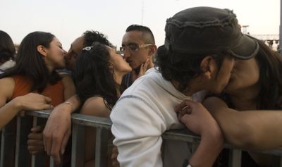 Couples kiss in Mexico City on Saturday to break the world record for the largest number of people kissing at one time.  (Associated Press / The Spokesman-Review)