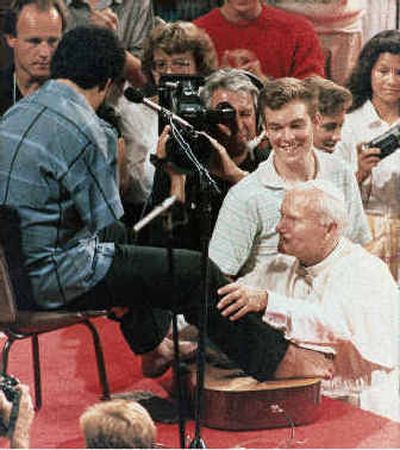 
Pope John Paul II embraces armless guitar player Tony Melendez after he strummed the guitar with his feet in 1987. 
 (Associated Press / The Spokesman-Review)