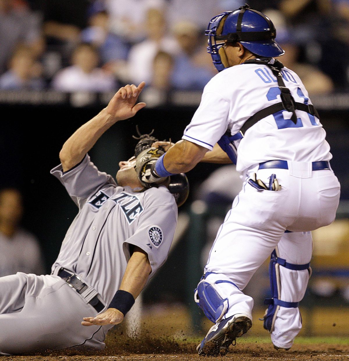 Russell Branyan of the Mariners is tagged out at home by Kansas City catcher Miguel Olivo.   (Associated Press / The Spokesman-Review)