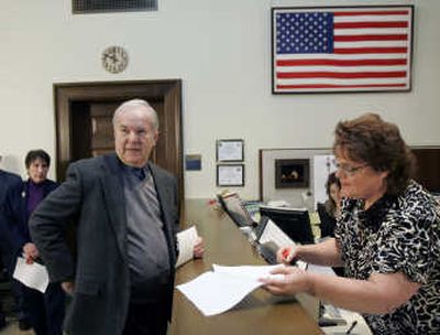 
Former Washington Gov. Booth Gardner files an initiative Wednesday with Teresa Glidden at the Deptartment of Elections  at the Capitol in Olympia. 
 (Associated Press / The Spokesman-Review)
