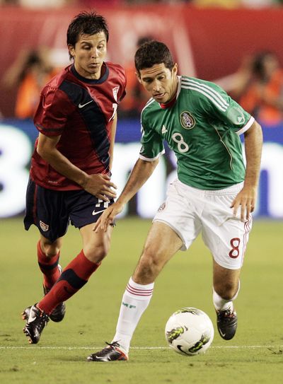 Jose Torres, left, and Mexico's Israel Castro compete for the ball. (Associated Press)