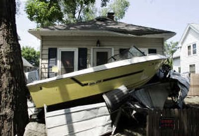 
Flooding washed a boat onto the front porch of a home in the Time Check neighborhood of Cedar Rapids, Iowa.
 (The Spokesman-Review)