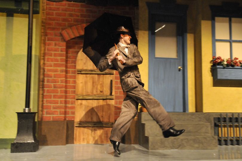 Ashton Toth plays Don Lockwood and sings the title song in a scene from “Singing in the Rain,” which is being staged at Central Valley High School. During the production real rain is generated by hoses in the rafters, and by the end of the number, Toth is soaked. (Jesse Tinsley)