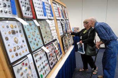 
Joann and Darrel Carlson, of Osburn, examine cards filled with buttons on display at the Idaho State Button Society show at the Best Western Coeur d'Alene Inn on Friday. The show includes competitions, discussions, lectures, a banquet and an exhibition. 
 (Jesse Tinsley / The Spokesman-Review)