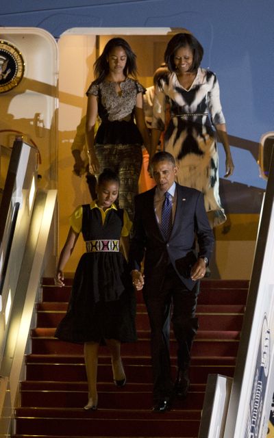 U.S. President Barack Obama, first lady Michelle Obama, and daughters Sasha, front left, and Malia descend from Air Force One as they arrive in Dakar, Senegal, on Wednesday. (Associated Press)