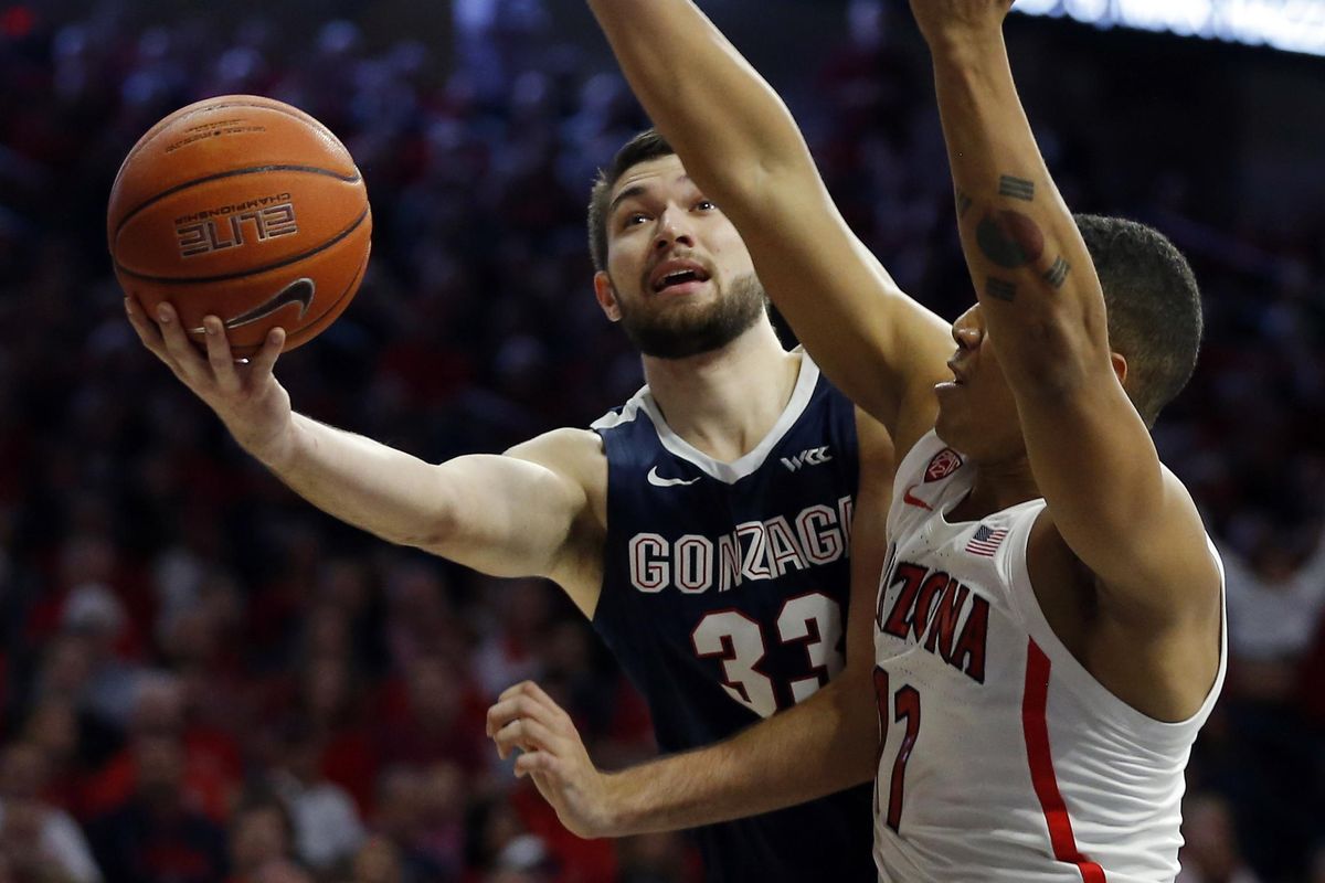 Gonzaga forward Killian Tillie (33) drives past Arizona forward Ira Lee in the first half of an NCAA college basketball game, Saturday, Dec. 14, 2019, in Tucson, Ariz. (Rick Scuteri / AP)