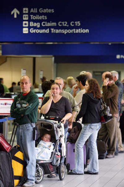 
American Airlines passengers line up at a check-in counter at the Dallas-Fort Worth International Airport on Wednesday.Associated Press
 (Associated Press / The Spokesman-Review)