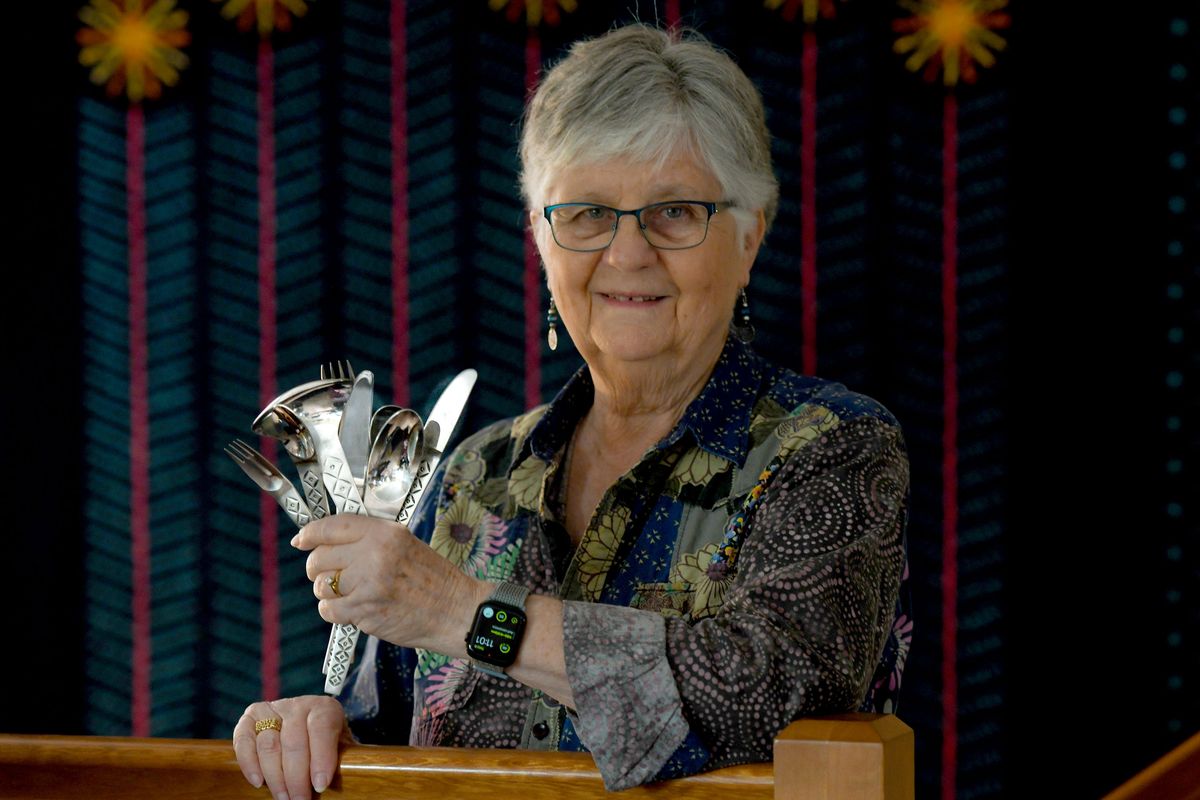 Collector Sue Burford holds a set of Stanley Roberts Maestro flatware, part of her midcentury modern flatware collection at her home in Spokane on April 6.  (Kathy Plonka/The Spokesman-Review)