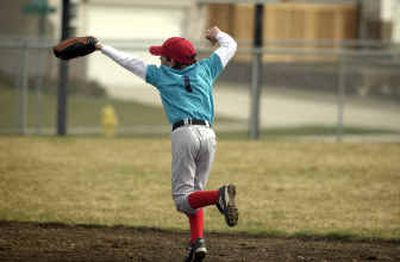 
Tanner Seaman runs to make a play during a Little League game at Canfield Sports Complex in Coeur d'Alene Saturday morning. 
 (Holly Pickett / The Spokesman-Review)