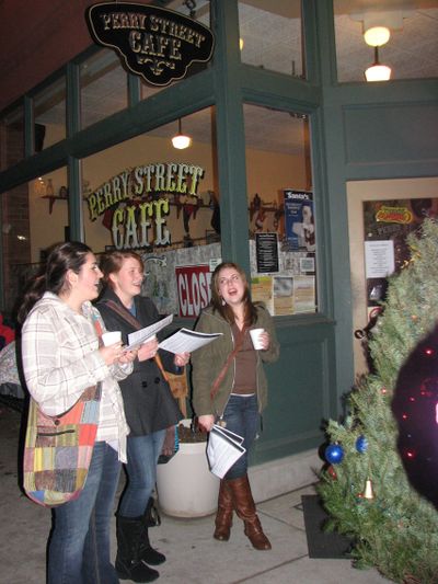 Neighbors sing carols outside the Perry Street Cafe on Dec. 13 2011