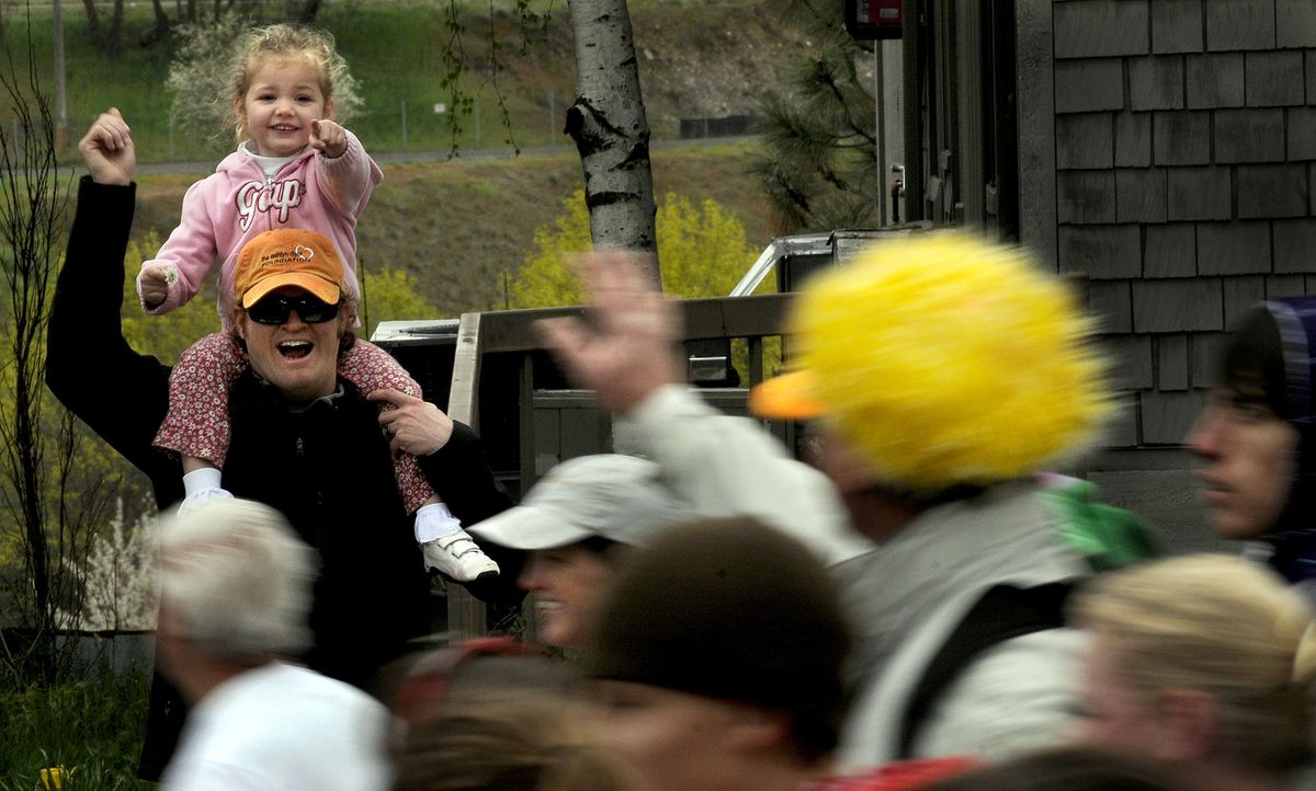 Three-year-old Lucy Low, of Seattle, was as excited as her uncle Kyle Smith, of Spokane, to see a clown running through Browne’s Addition.  (Kathy Plonka / The Spokesman-Review)