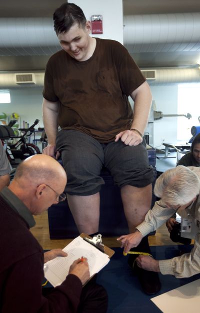 Igor Vovkovinskiy has his feet measured by shoe technicians at Reebok headquarters, in Canton, Mass., on Thursday. (Associated Press)
