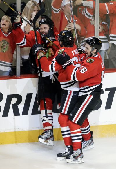 Brent Seabrook, rear, and teammates celebrate after scoring the winning goal. (Associated Press)