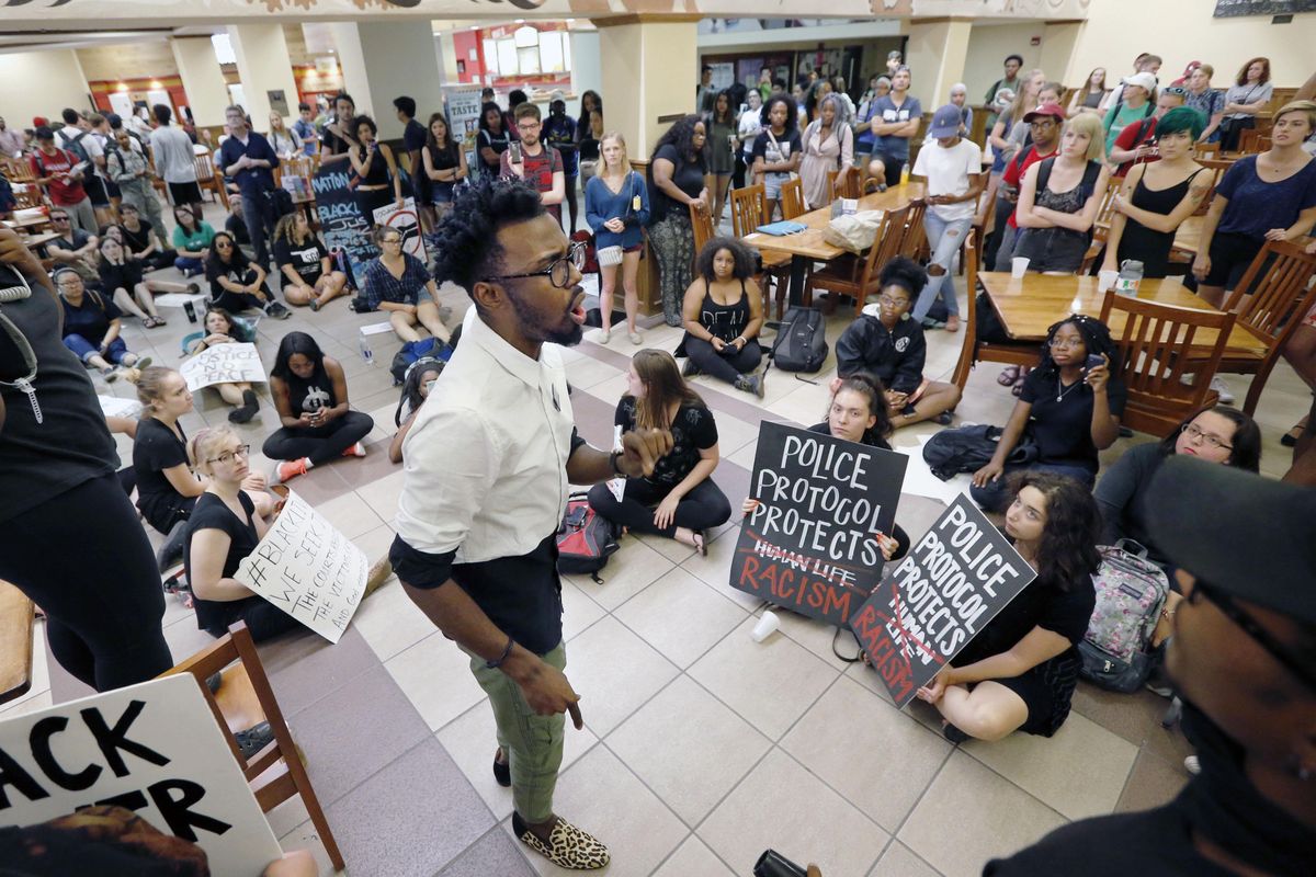 Quinton Dixon, Oklahoma University graduate student, speaks to protesters who filled the food court chanting “Black Lives Matter” in the Oklahoma Memorial Union at the University of Oklahoma on Thursday, Sept. 22, 2016 in Norman, Okla. Prosecutors in Tulsa, Oklahoma, charged a white police officer who fatally shot an unarmed black man on a city street with first-degree manslaughter Thursday. (Steve Sisney / Oklahoman via AP)