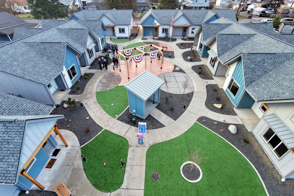 The Volunteers of America cut the ribbon Monday on a village of a dozen one-bedroom apartments created just for homeless military veterans near Lacey Street and Francis Avenue in north Spokane. Once approved to move in, the veterans can live there as long as they want. The courtyard landscaping was funded by a grant from the Spokane County veterans services office.  (Jesse Tinsley/THE SPOKESMAN-REVIEW)