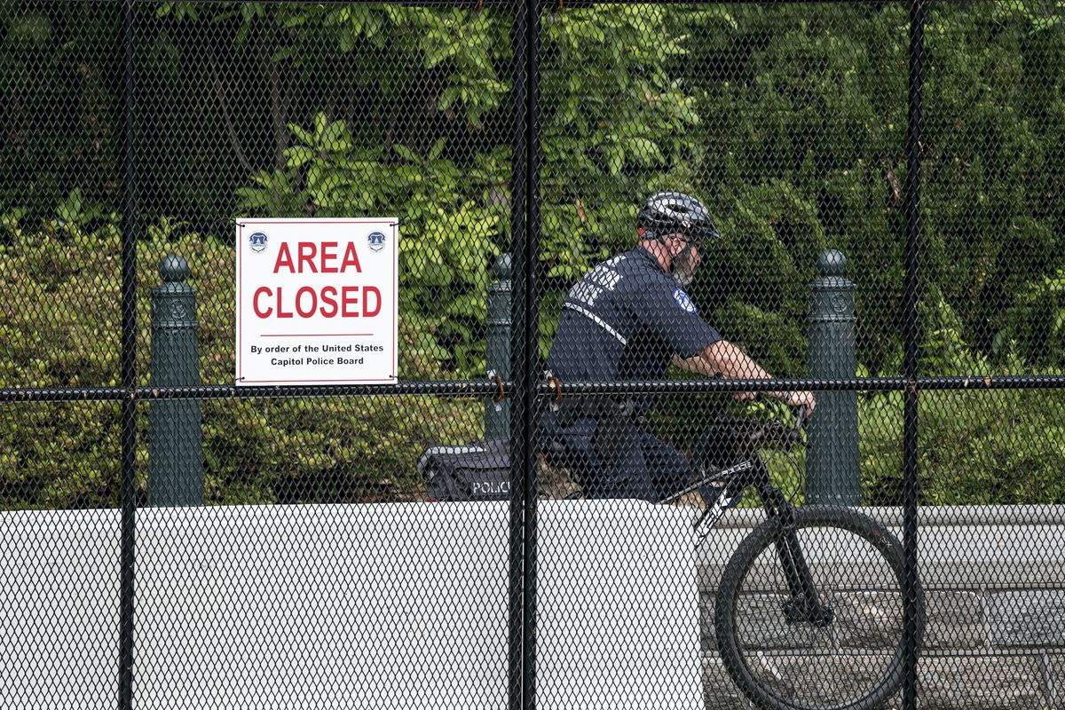 A U.S. Capitol Police officer patrols the barricaded perimeter of the Capitol grounds in Washington, Monday, June 14, 2021.  (J. Scott Applewhite)