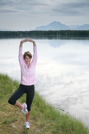 ORG XMIT: AK501 This May 2009 photo provided by Runner's World magazine shows Alaska Gov. Sarah Palin in a yoga pose near her home in Wasilla, Alaska. Palin says she'd come out ahead if she went one-on-one with fellow jogger President Barack Obama in a long run, according to an interview published online Tuesday, June 30, 2009. (AP Photo/Runner's World, Brian Adams) (Brian Adams / The Spokesman-Review)