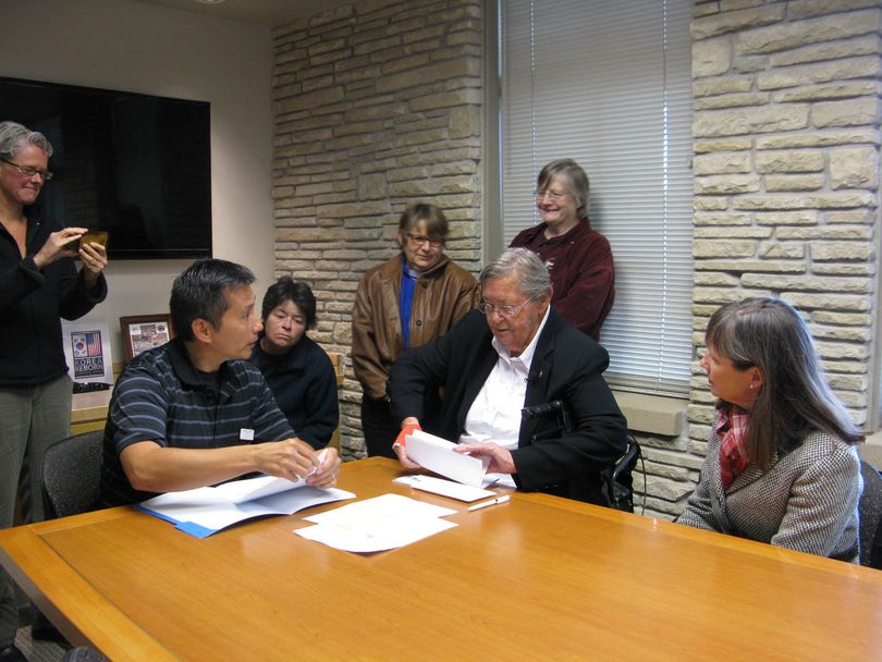 James Earp, left, director of the Idaho State Veterans Cemetery, helps Madelynn Lee Taylor, right, with the paperwork for interment of the ashes of her late wife, Jean Mixner, on Wednesday; the interment ceremony is scheduled for next week, after courts overturned Idaho's ban on recognition of same-sex marriages. (Betsy Russell)