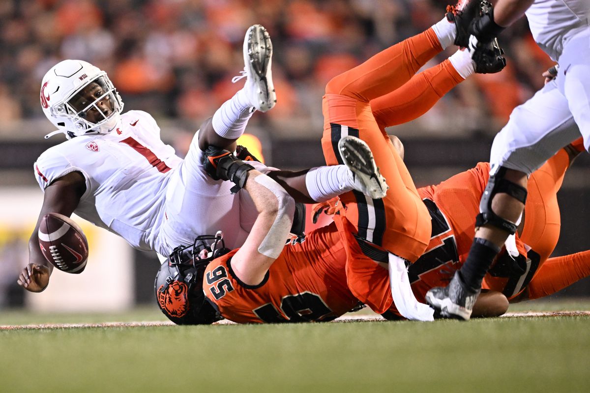 Washington State quarterback Cameron Ward loses control of the ball as he’s sacked by Oregon State linebacker Riley Sharp during the second half Saturday in Corvallis, Ore.  (Tyler Tjomsland/The Spokesman-Review)