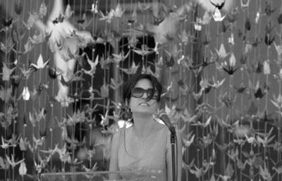 
Kati Kim speaks at a memorial for her husband, James Kim, in San Francisco on Saturday. James Kim died trying to save his stranded family. 
 (Associated Press / The Spokesman-Review)