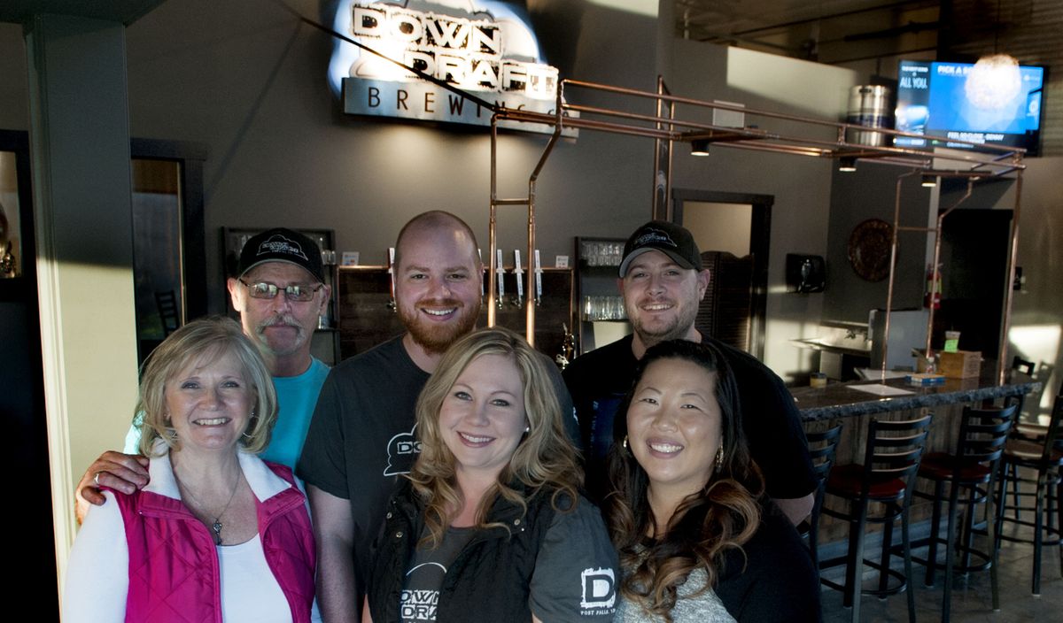 Owners of Downdraft Brewing, from left, Dee and Jerry Brayman, Andrea and Nolan Garrett, and Aimee and Nick Brayman gather for a group picture at the brewery in Post Falls last week. (Kathy Plonka)