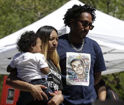 Salena Manni, the fiancee of police shooting victim Stephon Clark, holds the couple's son, Aiden as she and Clark's uncle, Curtis Gordon attend a rally aimed at ensuring Clark's memory and calling for police reform, Saturday, March 31, 2018, in Sacramento, Calif. (Rich Pedroncelli / Associated Press)