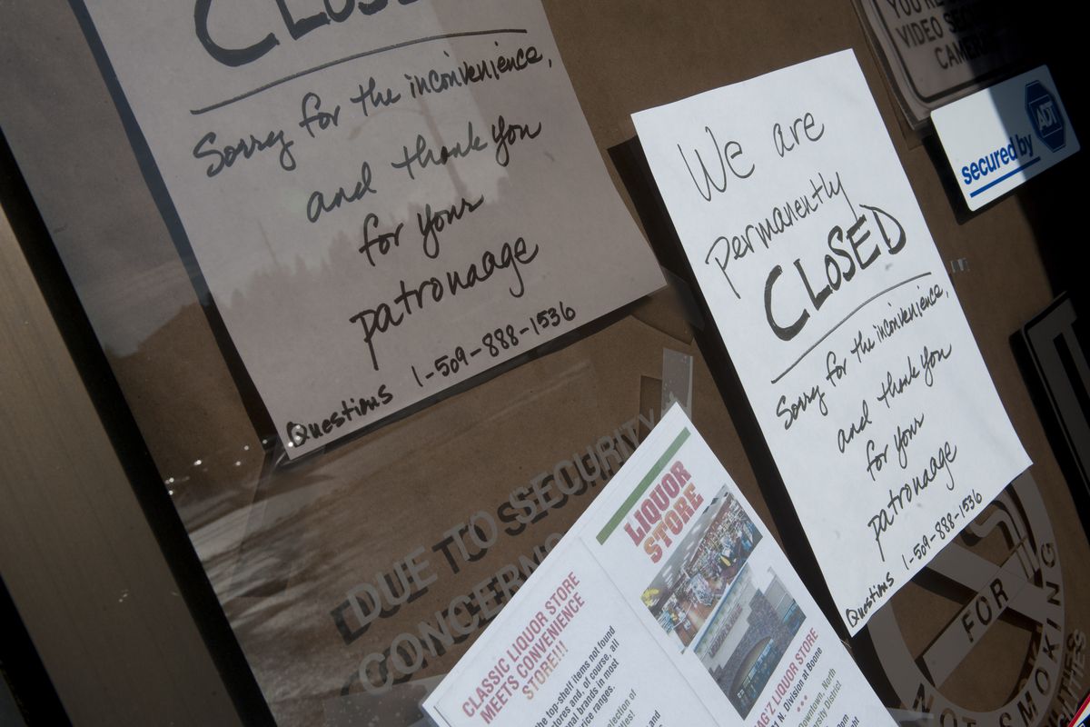 Closed signs cover the door of what was formerly Good Spirits liquor store at 1322 West Third Ave. in Spokane.