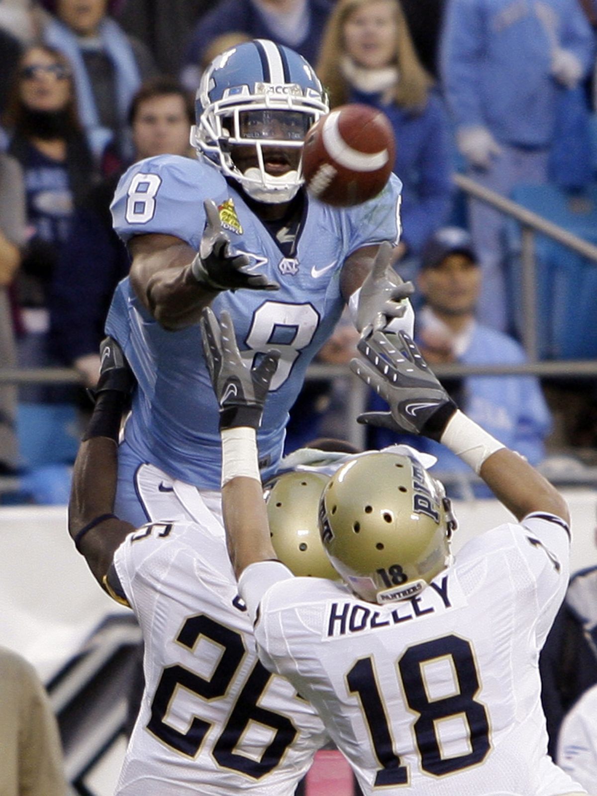 North Carolina’s Greg Little reaches for a touchdown pass against Panthers defensive backs Jarred Holley and Ricky Gary. (Associated Press)