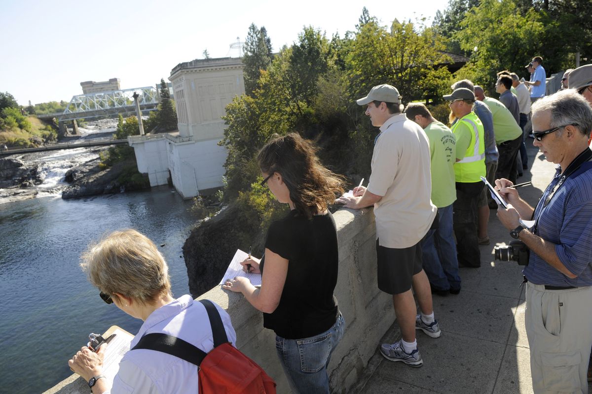 Evaluators from Avista, the Sierra Club, the Center for Environmental Law and Policy, the Department of Ecology and the city of Spokane record their scores while viewing the Spokane River Falls on Wednesday, Aug. 25, 2010. (Dan Pelle / The Spokesman-Review)