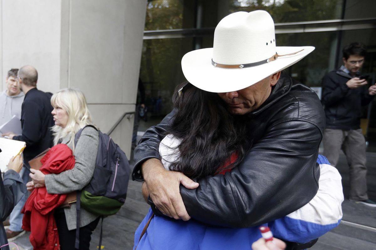 Defendant Shawna Cox speaks at left as supporters hug outside federal court in Portland, Ore., Thursday, Oct. 27, 2016. (Don Ryan / AP)