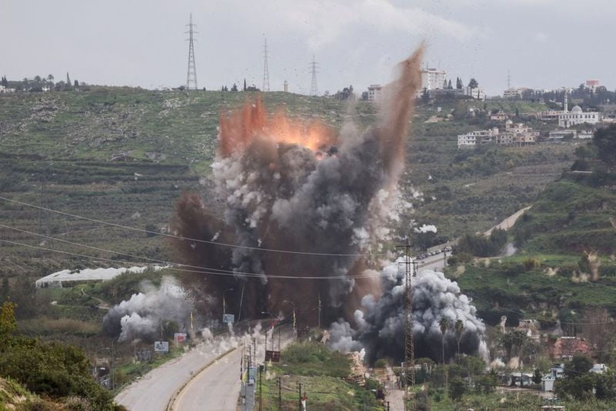 A firefighter works to douse a fire Sunday in Petah Tikva, Israel, following Iranian missile strikes amid the U.S.-Israel conflict with Iran. (Reuters )