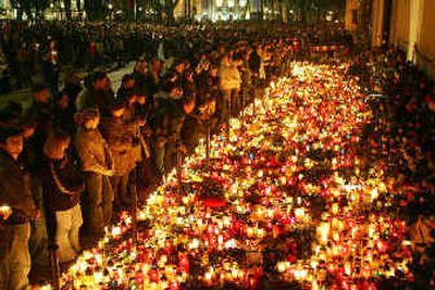 
People stand in front of a sea of burning candles at the bishop's residence in Krakow, Poland, on Sunday. Pope John Paul II served here as priest and bishop under his given name, Karol Wojtyla. 
 (Associated Press / The Spokesman-Review)