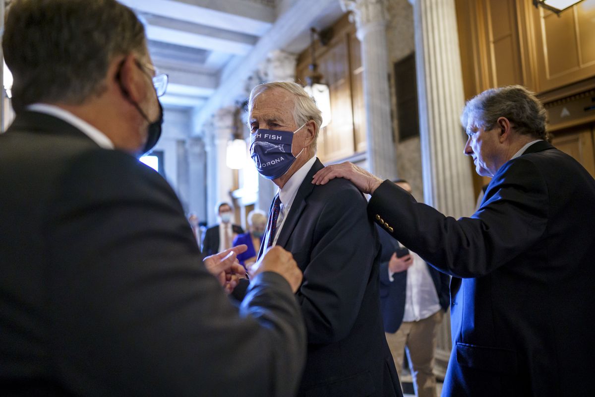 Sen. Angus King, I-Maine, center, speaks with Sen. Gary Peters, D-Mich., left, while Sen. John Kennedy, R-La., walks by at right, as the Senate votes to formally begin debate on a roughly $1 trillion infrastructure plan, a process that could take several days, at the Capitol in Washington, Friday, July 30, 2021.  (J. Scott Applewhite)