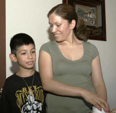 
Elvira Arellano smiles as she looks down at her son, Saul, after they were reunited in Tijuana, Mexico, on Monday. Associated Press
 (Associated Press / The Spokesman-Review)