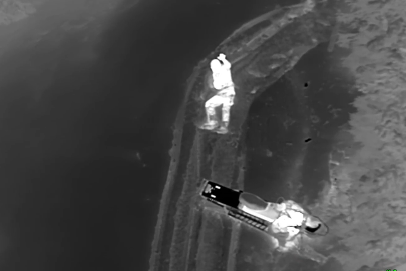 An injured 19-year-old man waves at a Two Bear Air helicopter crew as they perform a night rescue after the snowmobiler crashed into a gate in Montana on March 19, 2016.  (Two Bear Air)