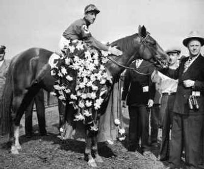 Whirlaway, with jockey Eddie Arcaro and trainer Ben Jones, right, stands in the winner's circle after his 1941 Belmont Stakes win.
(Associated Press / The Spokesman-Review)
