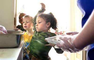 
Jayden Karkham, 5, left, and Alicia Lucht, 5, right, try to decide between chocolate and regular milk at lunch at the Central Valley Kindergarten Center. Overflow students from all over the district attend the school.
 (Joe Barrentine / The Spokesman-Review)