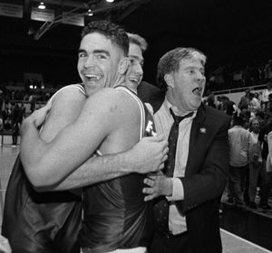 Gonzaga's Matt Stanford, foreground, hugs teammate Jeff Brown as they celebrate with head coach Dan Fitzgerald, right, after beating Stanford 80-67 at Stanford in 1994. (Anderson Anderson)