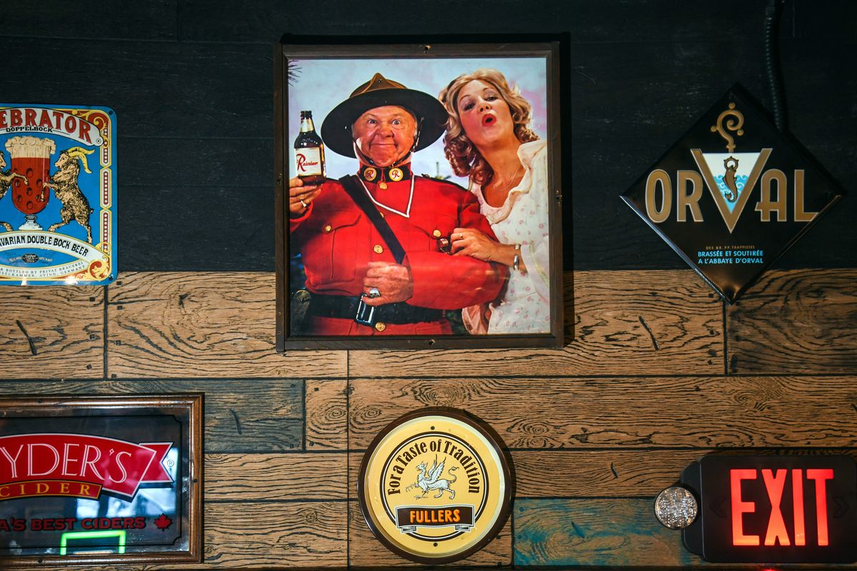 Photo of old Rainier Brewery poster depicting Mickey Rooney sits above the entrance at The Viking pub in Spokane in 2018.  (Dan Pelle/THE SPOKESMAN-REVIEW)