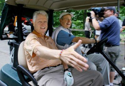 
Former President Bill Clinton, left, reaches to shake a hand of a well wisher as he and former President George H.W. Bush head off to start a round of golf in June at the Cape Arundel Golf Club in Kennebunkport, Maine. 
 (Associated Press / The Spokesman-Review)