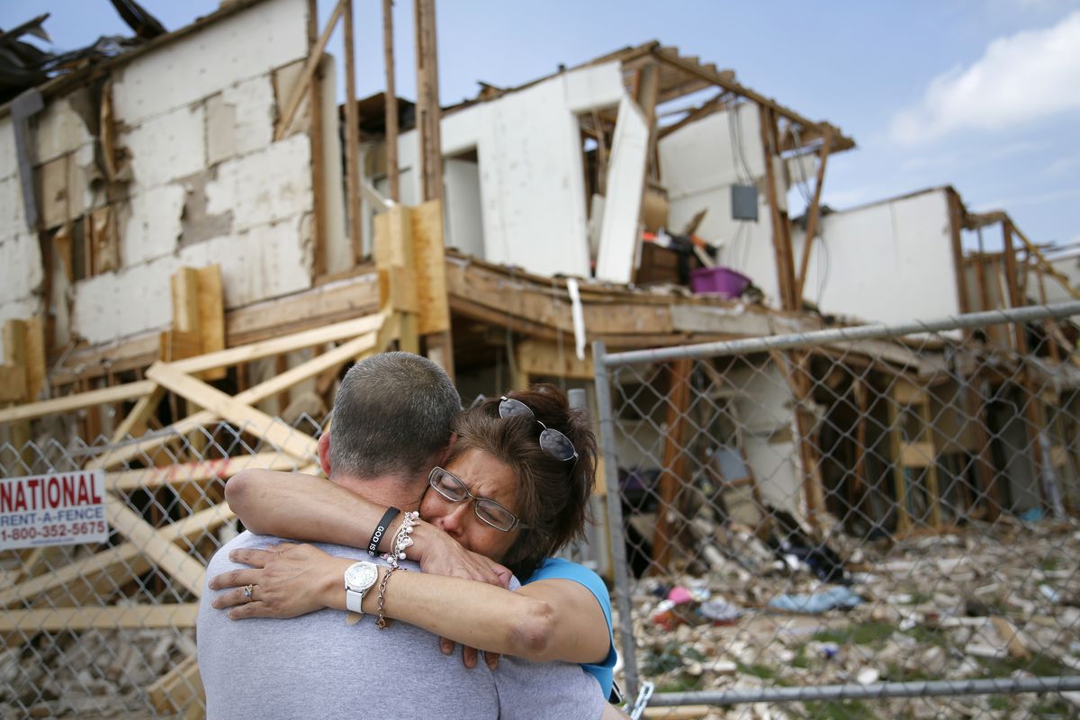Shona Jupe, a resident of a West, Texas, apartment destroyed by the fertilizer plant explosion, hugs a friend while visiting the site on Friday. (Associated Press)